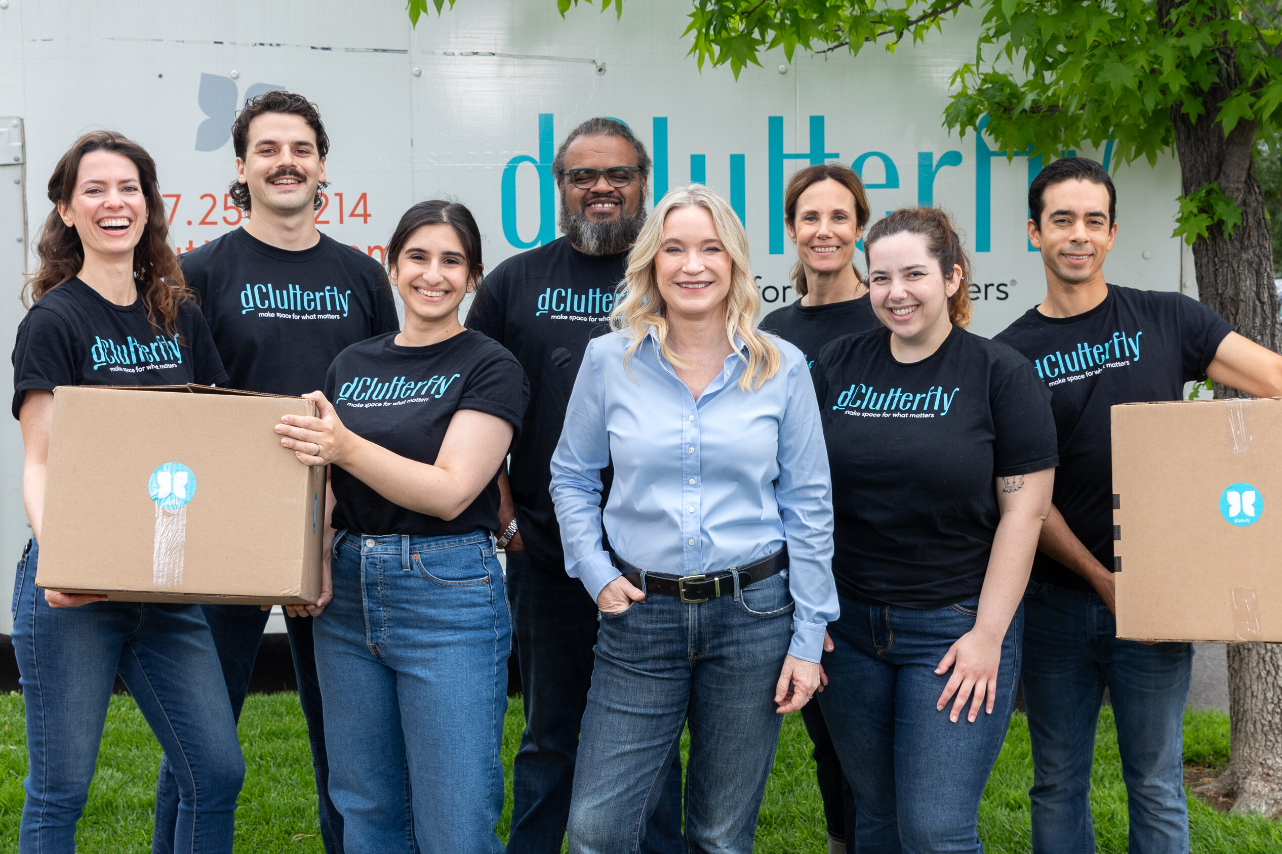 Tracy McCubbin and the dClutterfly team stand together as a group